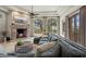 Spacious living room with a cozy fireplace and large windows at 10721 E La Junta Rd, Scottsdale, AZ 85255