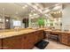 Bathroom with double vanity, stone countertops and large mirrors at 10721 E La Junta Rd, Scottsdale, AZ 85255