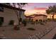 Evening view of the home's exterior, showcasing its landscaping and architecture at 10721 E La Junta Rd, Scottsdale, AZ 85255