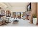 Living room with a stone fireplace and large windows at 10721 E La Junta Rd, Scottsdale, AZ 85255