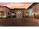 Elegant entryway with a grand iron door and paver driveway at 10721 E La Junta Rd, Scottsdale, AZ 85255