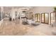 Spacious living area with a fireplace and access to a patio at 10721 E La Junta Rd, Scottsdale, AZ 85255