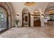 Elegant entry with tile floors, ornate door, and built-in shelving at 10721 E La Junta Rd, Scottsdale, AZ 85255
