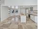 Modern kitchen with white cabinets, a large island, and tile floors at 4801 E Nisbet Rd, Scottsdale, AZ 85254