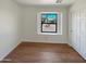 Well-lit bedroom with wood-look floors and a large window at 4801 E Nisbet Rd, Scottsdale, AZ 85254