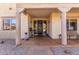 Elegant front entry with a covered porch, wood columns and a decorative door at 10731 E Hillview St, Mesa, AZ 85207