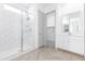 Modern bathroom with white subway tile, glass shower, and herringbone floor at 5940 S Cobalt --, Mesa, AZ 85212