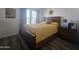 Comfortable bedroom with wood flooring and a large window at 8700 E University Dr # 339, Mesa, AZ 85207