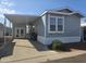 Mobile home with covered carport and landscaping at 8700 E University Dr # 339, Mesa, AZ 85207