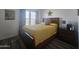 Second bedroom with wood floors and a comfortable bed at 8700 E University Dr # 339, Mesa, AZ 85207