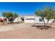 White single story home with landscaped yard and two car garage at 8901 N 87Th Ct, Scottsdale, AZ 85258