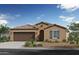 Tan single story home with brown garage door and green shutters at 5928 S 246Th Ln, Buckeye, AZ 85326
