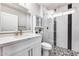 Updated bathroom with white vanity, marble shower, and hexagon tile floor at 10718 W El Capitan Cir, Sun City, AZ 85351