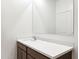 Simple bathroom with white vanity and large mirror at 5420 S 253Rd Ln, Buckeye, AZ 85326