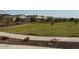 Community park with a walking path and homes in the background at 5420 S 253Rd Ln, Buckeye, AZ 85326