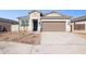 Single story home with two car garage and desert landscaping at 5420 S 253Rd Ln, Buckeye, AZ 85326