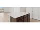 Modern kitchen island with white quartz countertop and dark brown cabinets at 5420 S 253Rd Ln, Buckeye, AZ 85326