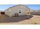 Backyard with gravel landscaping and AC unit at 5420 S 253Rd Ln, Buckeye, AZ 85326