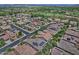 Aerial view of community with solar panels and lush landscaping at 13055 W Eagle Talon Trl, Peoria, AZ 85383