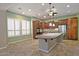 Island kitchen with granite counters, stainless steel appliances, and custom cabinetry at 13055 W Eagle Talon Trl, Peoria, AZ 85383