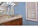 Bathroom with vanity, sink, and large mirror at 13055 W Eagle Talon Trl, Peoria, AZ 85383