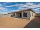 Rear view of house showcasing patio and backyard at 262 S 164Th Dr, Goodyear, AZ 85338