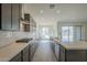 Modern kitchen with gray cabinetry, quartz countertops, and stainless steel appliances at 262 S 164Th Dr, Goodyear, AZ 85338