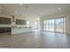 Open concept kitchen and dining area with gray tile floors and access to backyard at 262 S 164Th Dr, Goodyear, AZ 85338