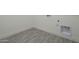 Laundry room with gray tile floor and built-in storage at 262 S 164Th Dr, Goodyear, AZ 85338