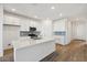 Modern kitchen with white cabinets, a large island, and tile flooring at 4226 E Bradford Ave, San Tan Valley, AZ 85143