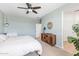 Bright bedroom with ceiling fan and wood dresser at 3719 E Henson St, San Tan Valley, AZ 85140