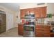 Kitchen boasting stainless steel appliances and wood cabinets at 13408 N Cedar Dr, Sun City, AZ 85351