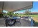 Covered patio with table and chairs, overlooking the backyard at 13408 N Cedar Dr, Sun City, AZ 85351