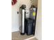 Garage interior with water softener and water heater at 9510 W Menadota Dr, Peoria, AZ 85382