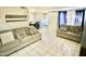 Living room with tiled floor, sofa, and dining area at 5418 W Belleview St, Phoenix, AZ 85043