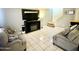 Living room with tiled floors, two sofas, and a fireplace at 5418 W Belleview St, Phoenix, AZ 85043