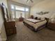 Main bedroom with carpeted floors, ample natural light, and wooden furniture at 15406 W Sky Hawk Dr, Sun City West, AZ 85375