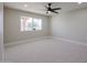 Bedroom with ceiling fan and large window at 13221 W Mesa Verde Dr, Sun City West, AZ 85375