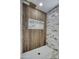 Walk-in shower with wood-look tile and marble accents at 3981 N 155Th Ave, Goodyear, AZ 85395