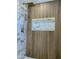 Modern shower with wood-look tile, marble accents, and rainfall shower head at 3981 N 155Th Ave, Goodyear, AZ 85395