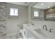 Bathroom with double vanity, quartz countertops, and tile shower surround at 3981 N 155Th Ave, Goodyear, AZ 85395