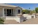 Spacious backyard with patio, decorative bowls, and gravel landscaping at 3981 N 155Th Ave, Goodyear, AZ 85395