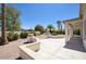 Landscaped backyard with patio, decorative bowls, and mature trees at 3981 N 155Th Ave, Goodyear, AZ 85395