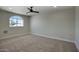 Well-lit bedroom featuring carpet, ceiling fan, and a large window at 3981 N 155Th Ave, Goodyear, AZ 85395