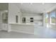 Bright kitchen with white cabinets, quartz countertops, and an island at 3981 N 155Th Ave, Goodyear, AZ 85395