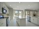 Spacious kitchen boasts an island, white cabinets, and plenty of natural light at 3981 N 155Th Ave, Goodyear, AZ 85395