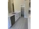 Kitchen features white cabinets, quartz countertops and a walk-in pantry at 3981 N 155Th Ave, Goodyear, AZ 85395
