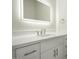 Modern bathroom with white cabinets, quartz countertop, and lighted mirror at 3981 N 155Th Ave, Goodyear, AZ 85395