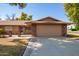 Single story home with attached two-car garage and brick facade at 15462 N Lakeforest Dr, Sun City, AZ 85351