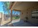 Covered patio and grassy backyard with block wall at 913 S 115Th Dr, Avondale, AZ 85323